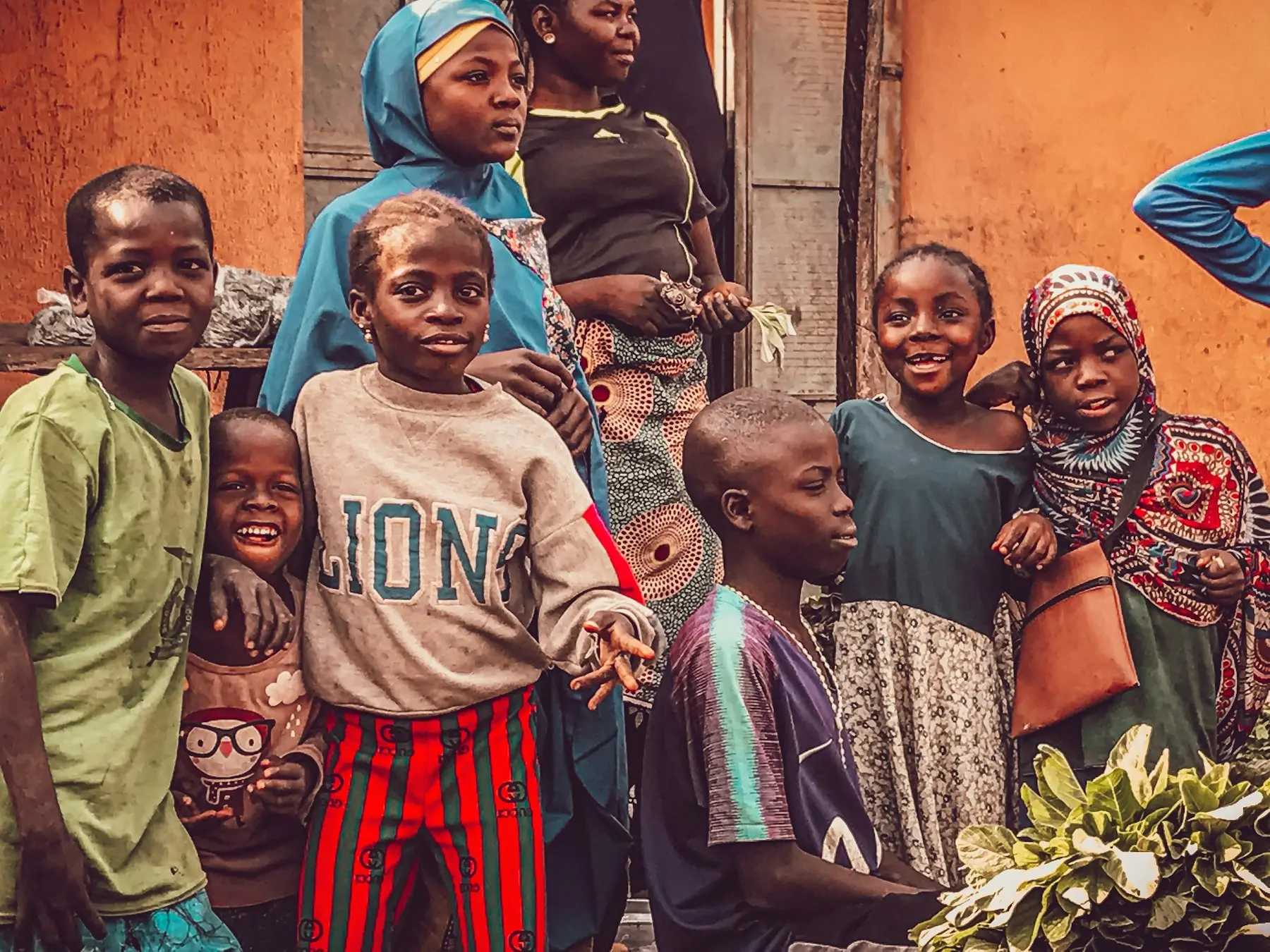 Children and mothers gathered outside their home in a Nigerian neighborhood